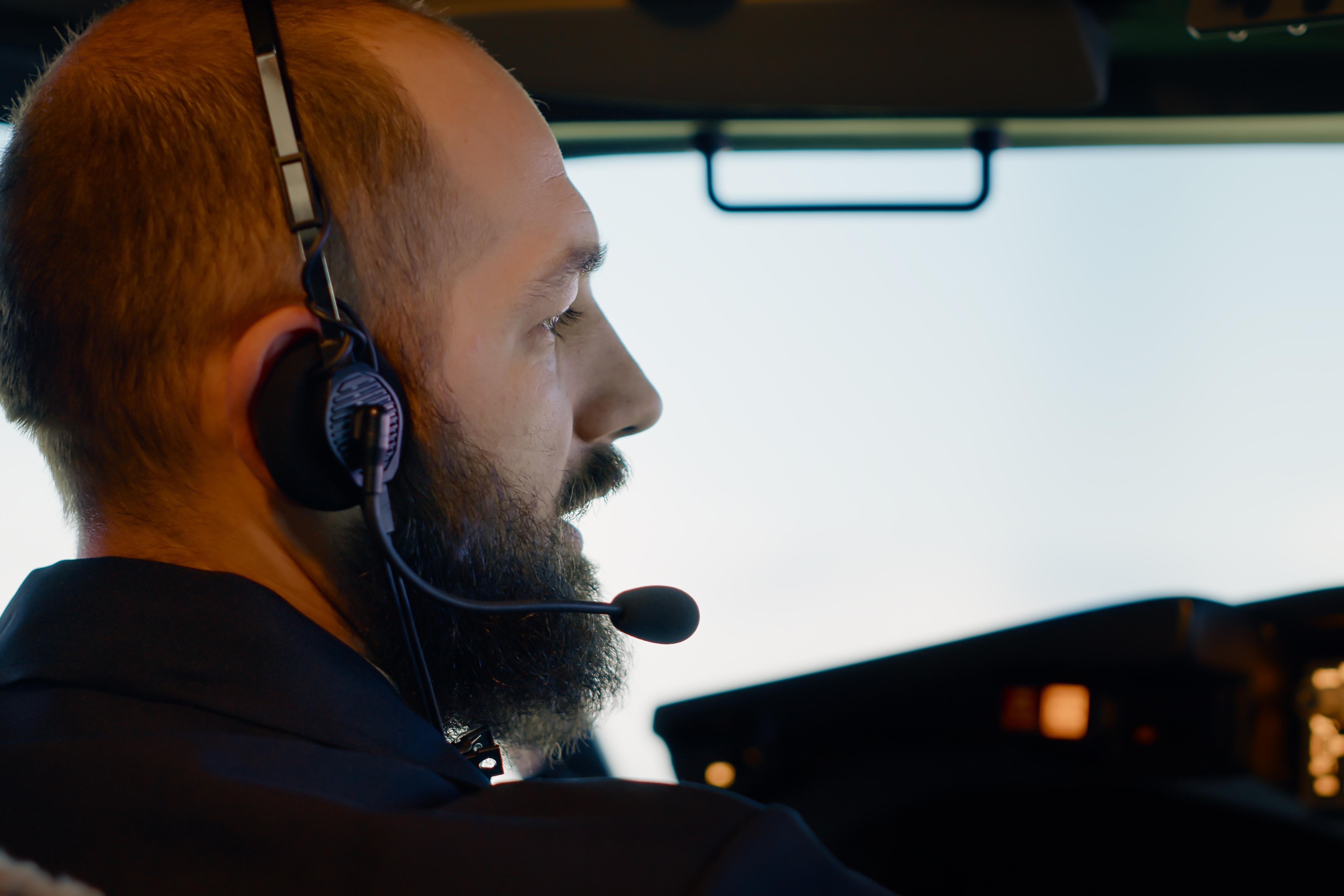 male-captain-pilot-flying-airplane-with-dashboard-command-using-aerial-navigation-takeoff-control-panel-buttons-with-radar-compass-windscreen-international-flight-service-close-up