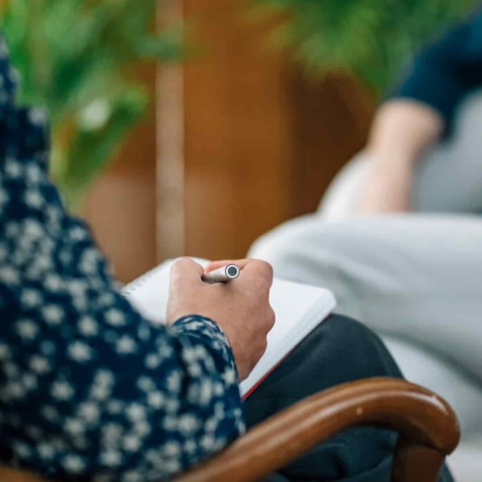 person-in-therapy-session-taking-notes-2026-01-05-06-23-20-utc (1)
